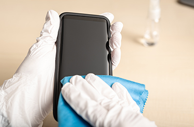 cleaning-smartphone-with-disinfectant photo